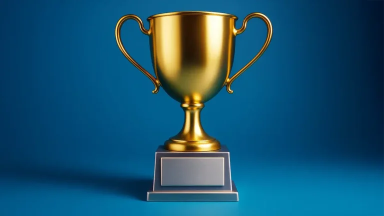 Golden trophy cup with blank nameplate on clean blue background