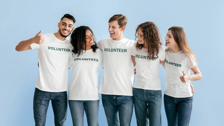 group of volunteers wearing matching white "volunteer" shirts thanks to custom shirt printing