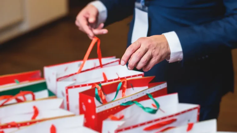 a man grabs a corporate Christmas gift bag